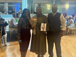 A group of people are standing next to each other in a room.