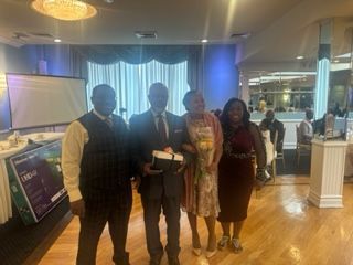 A group of people are posing for a picture in a room.