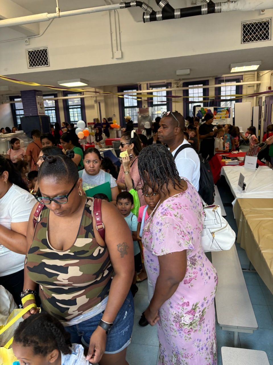 A crowd of people are gathered in a large room
