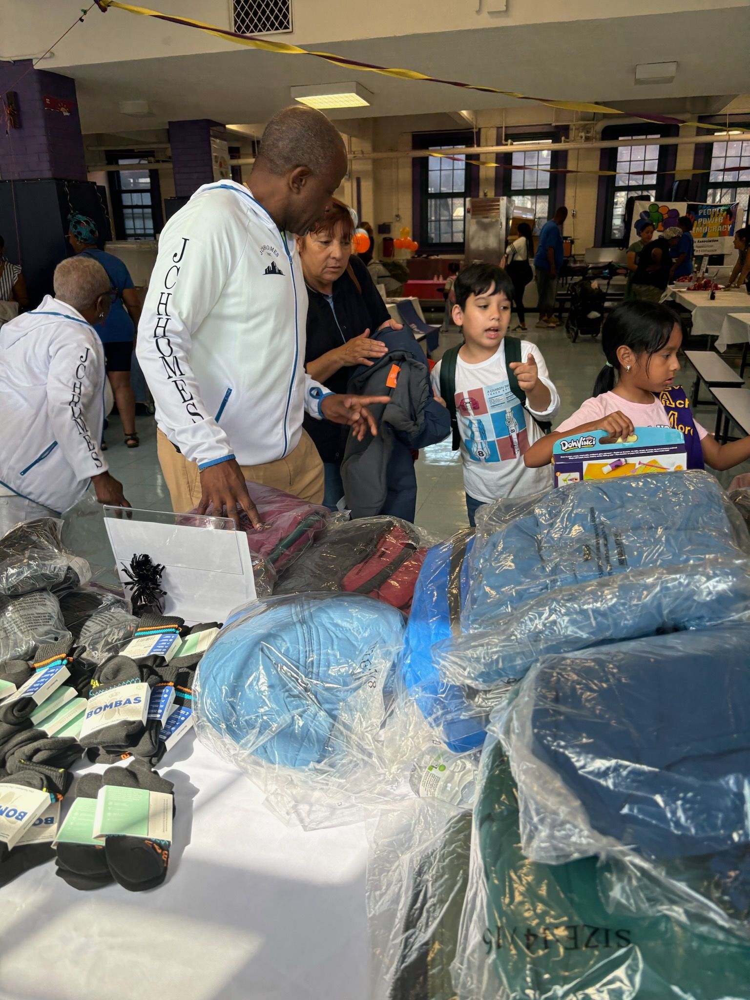 A group of people are standing around a table in a room.