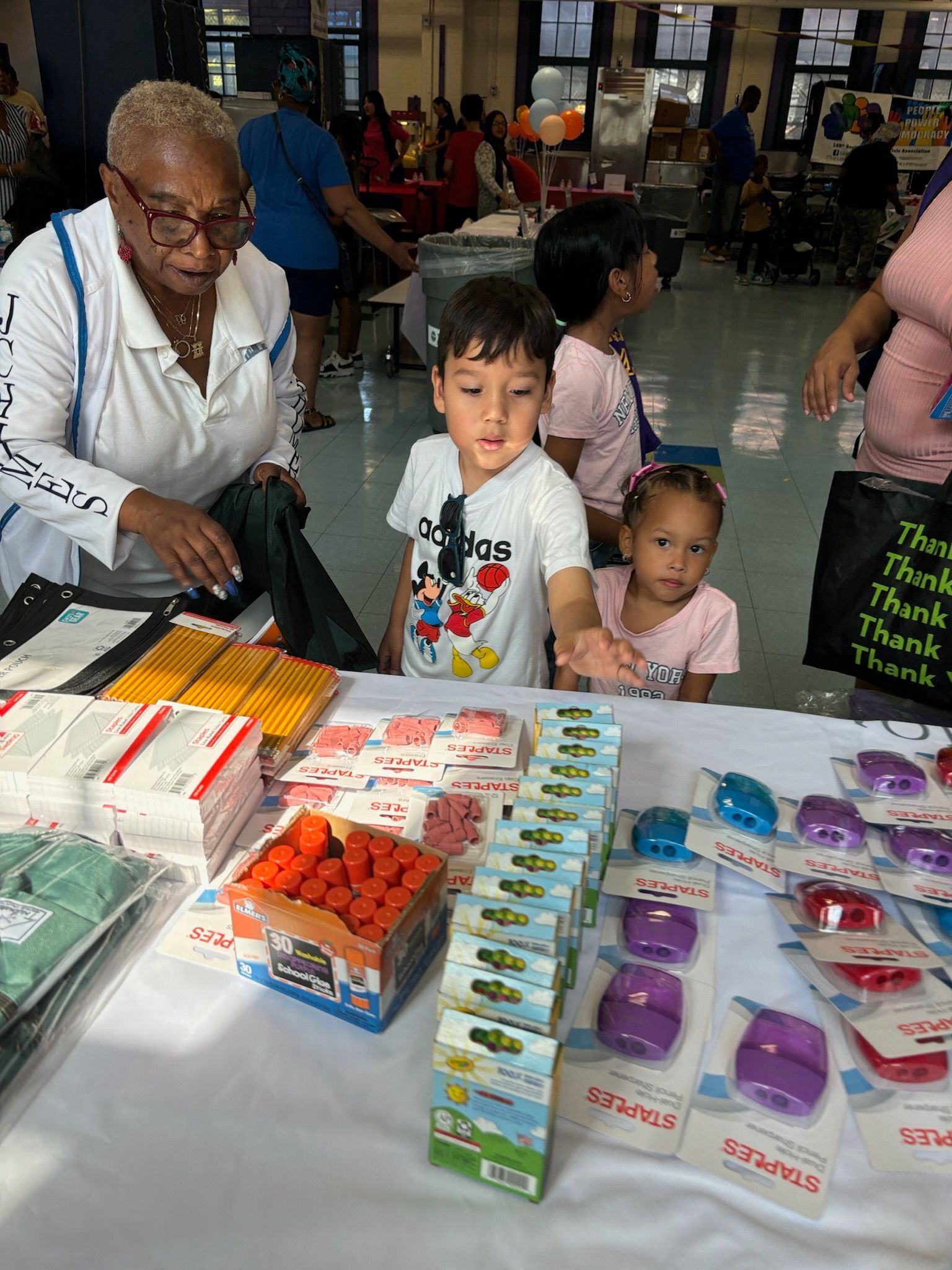 A woman is sitting at a table with a boy and a girl.