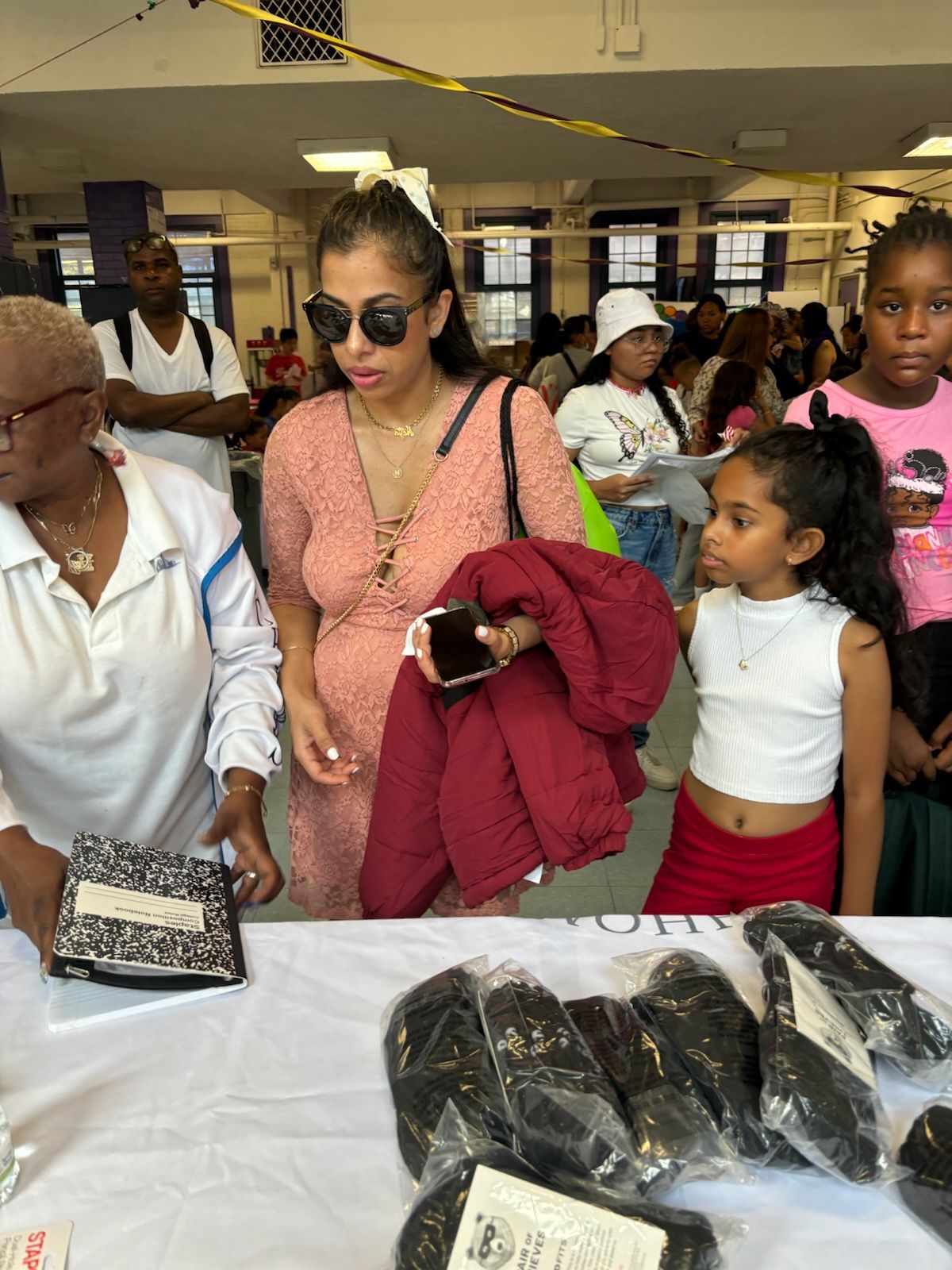 A group of people are standing around a table in a room.