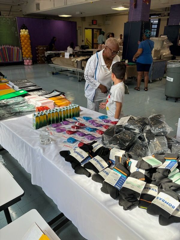 A man and a boy are looking at socks on a table.