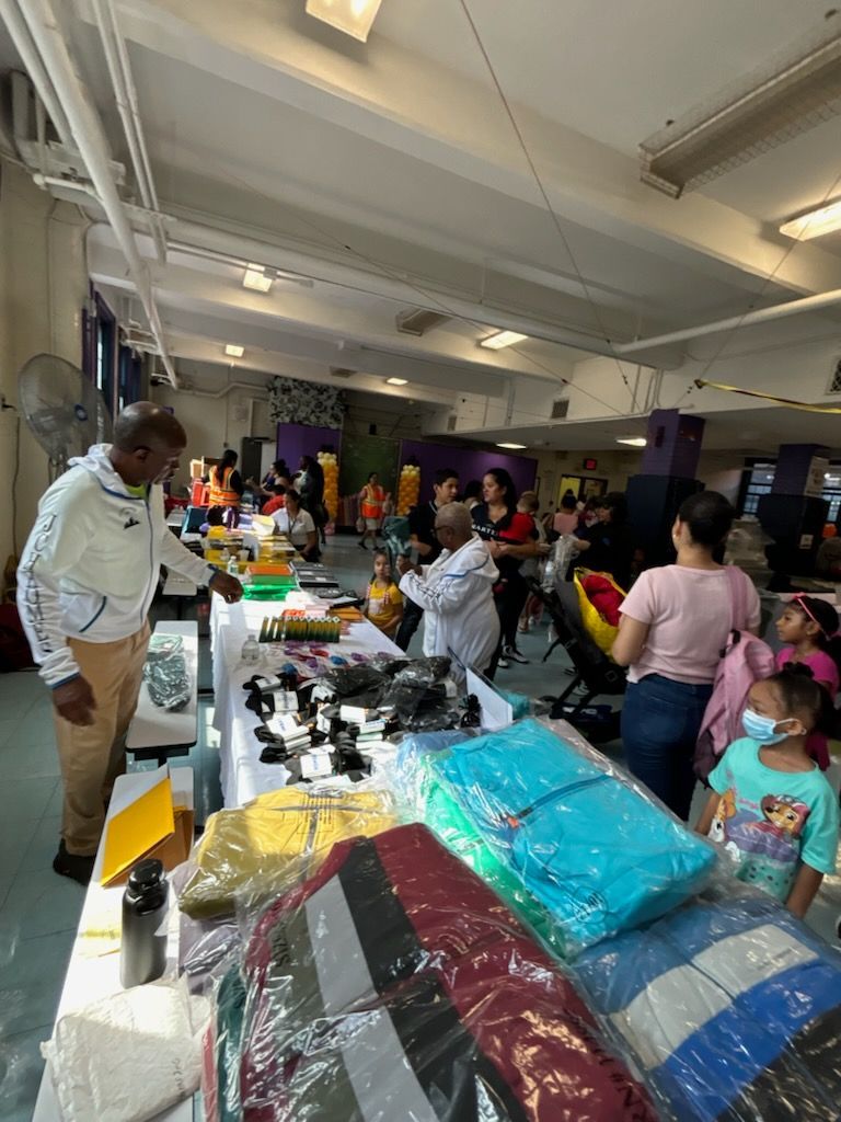 A group of people are standing around a table in a room.