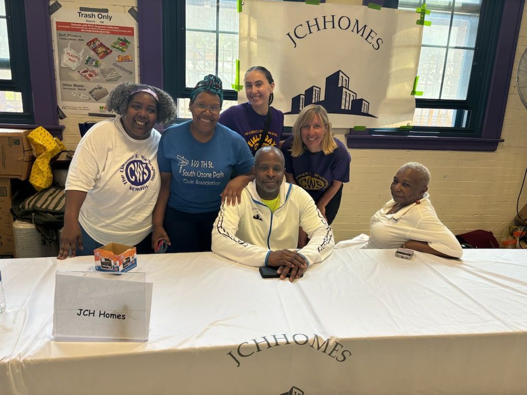 A group of people are posing for a picture at a table.
