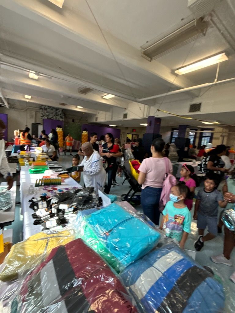 A group of people are standing around a table in a store.