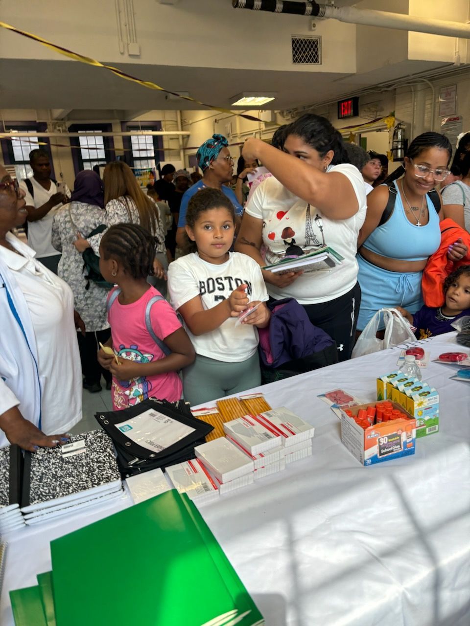 A group of people are standing around a table in a room.