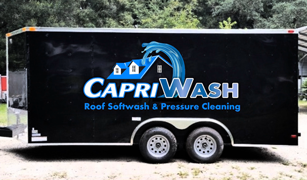 Black trailer with Capri Wash logo: a house with a wave, roof washing business.