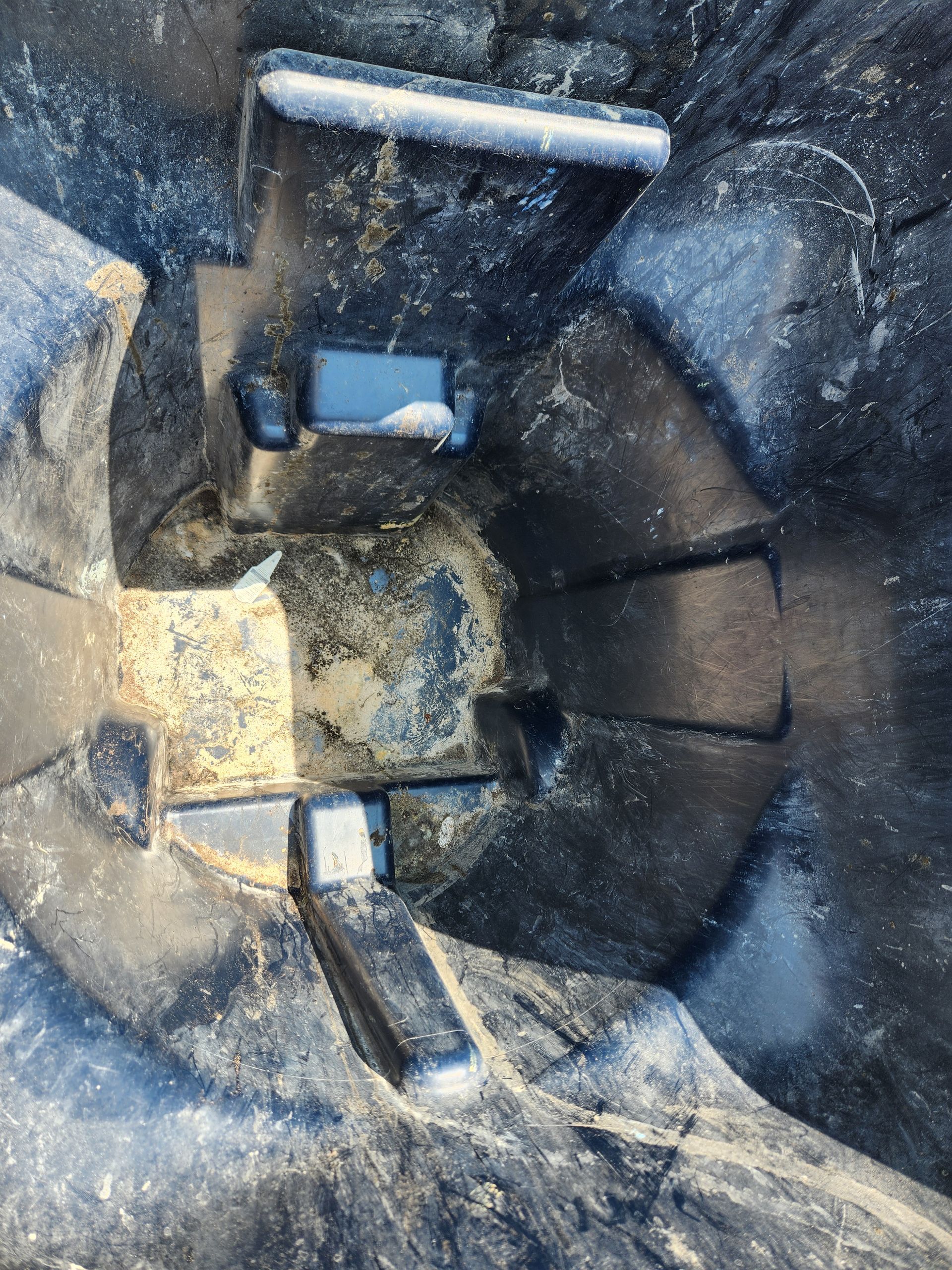 A man is sitting in a chair looking at his cell phone.