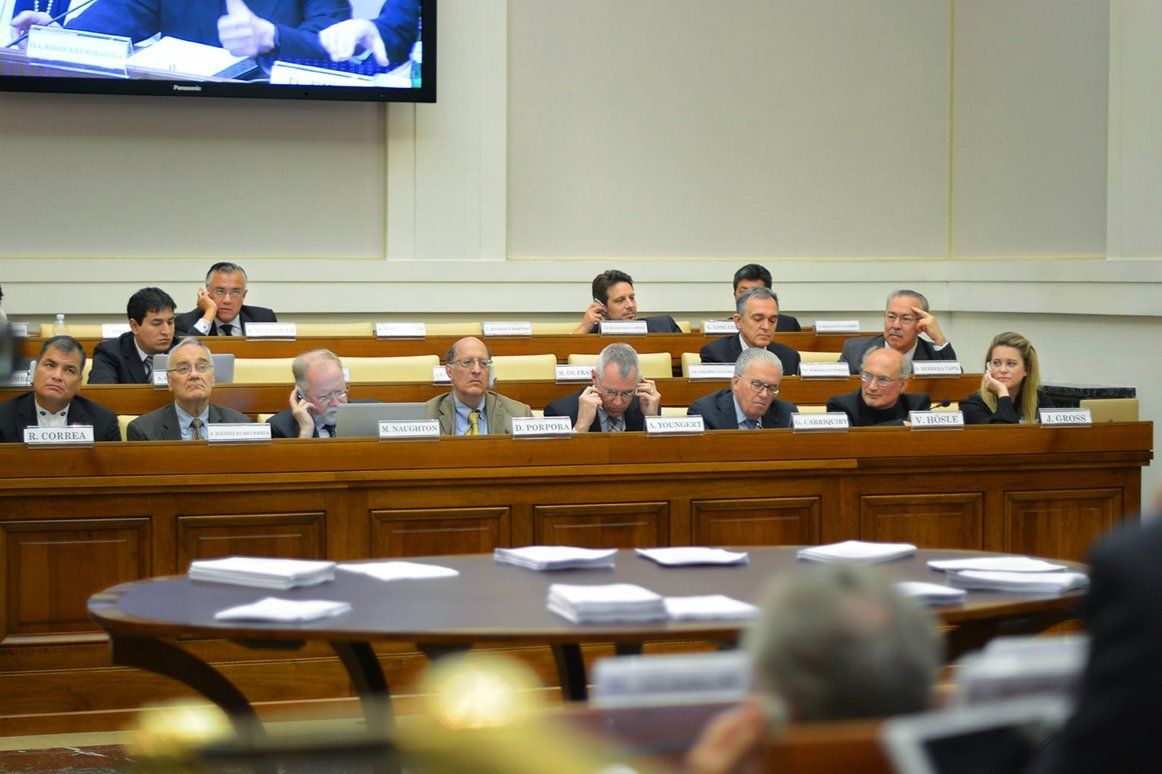 A group of people are sitting at a table in a classroom