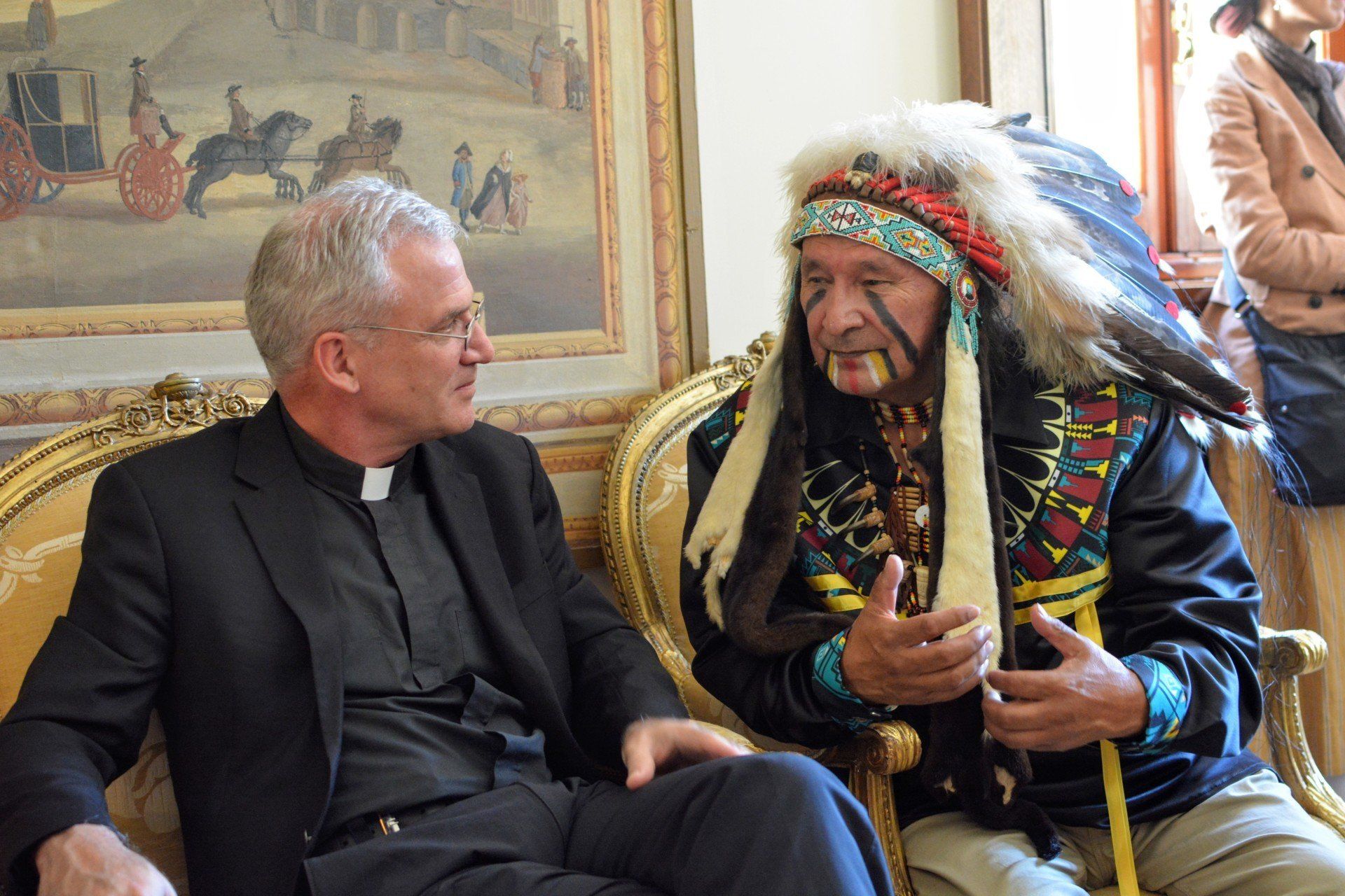 Two men talking at the Ethics in  Action and Indigenous Peoples meeting
