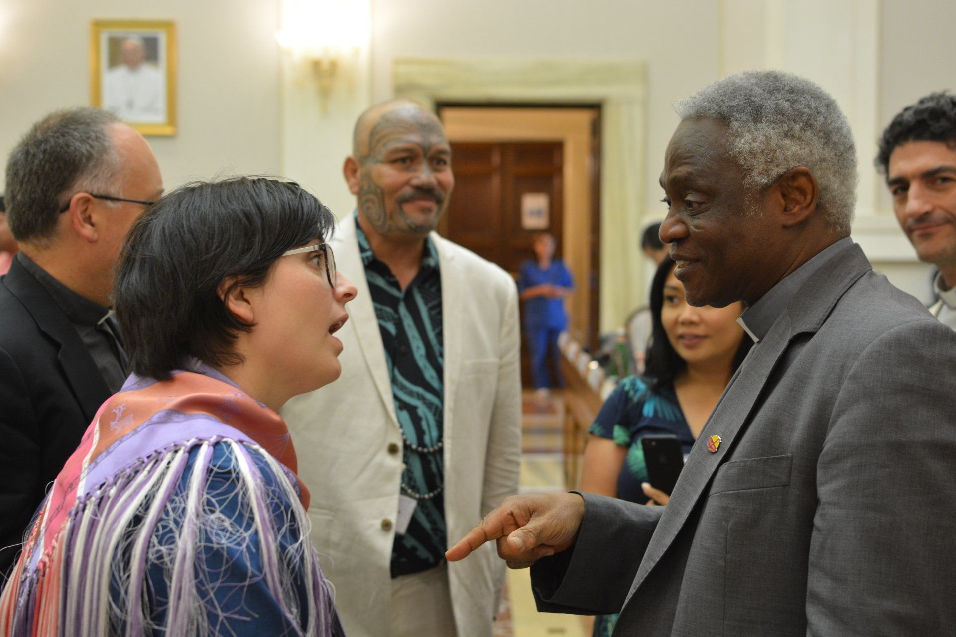 A group of people talking at the Ethics in  Action and Indigenous Peoples meeting