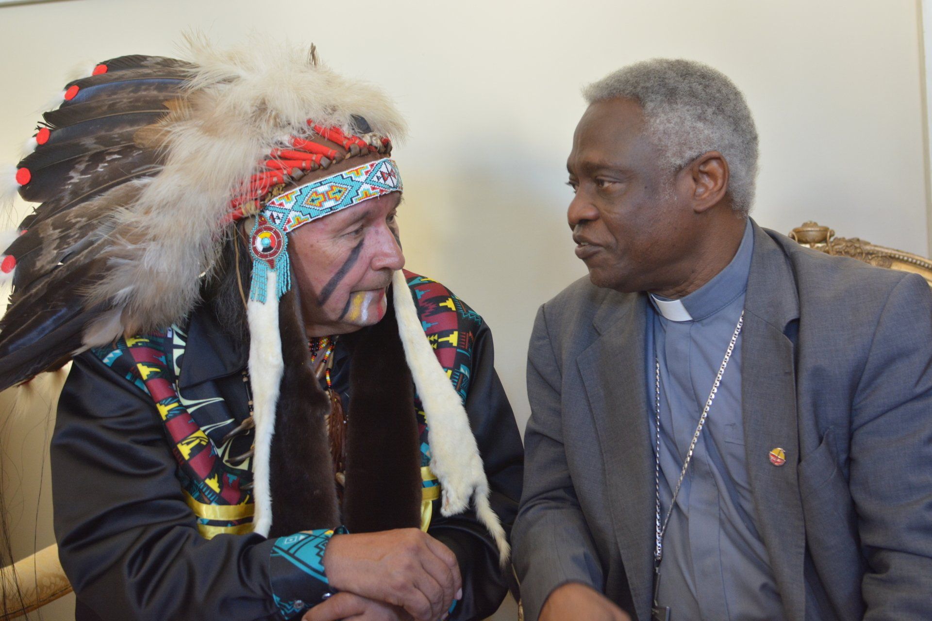 Indigenous man talking with another man. Ethics in action meeting.