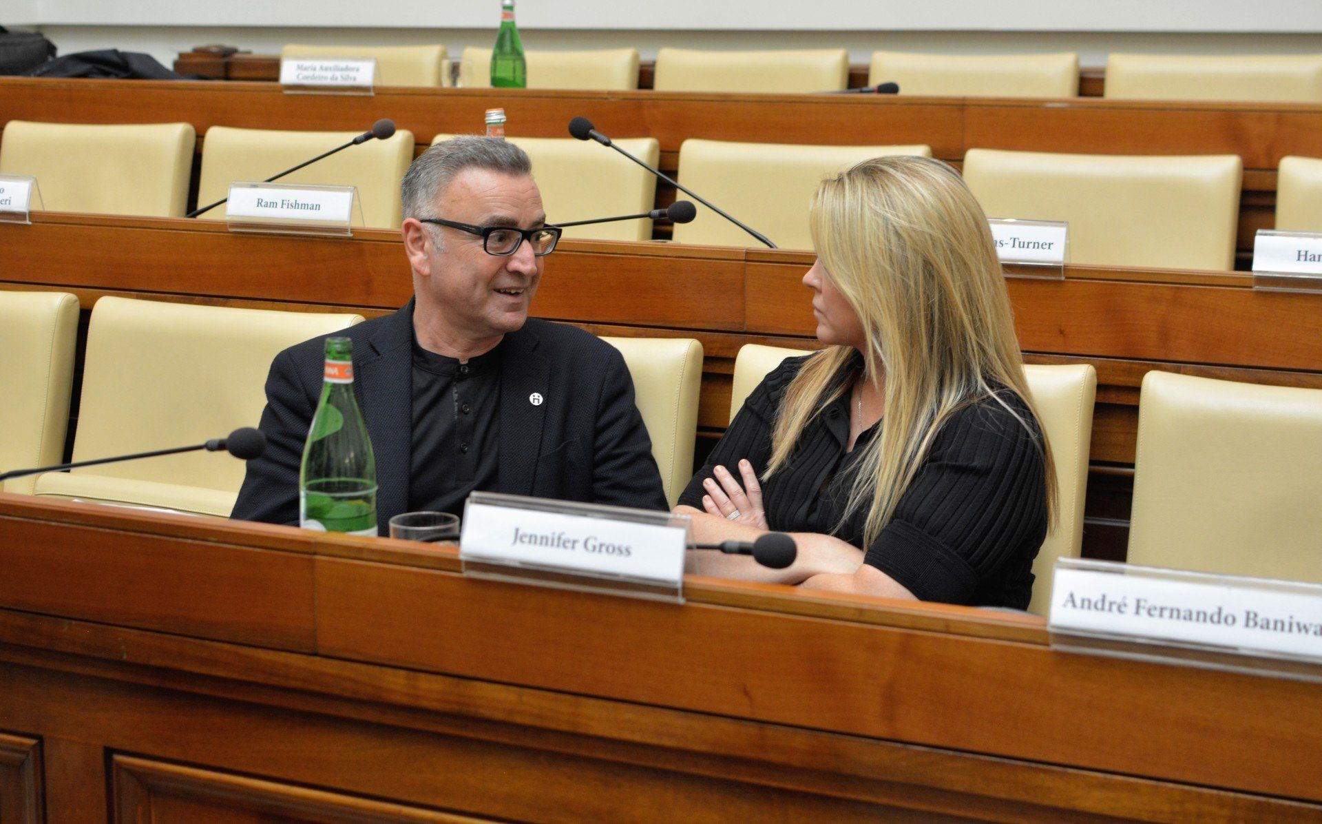 Jenifer Gross talking with a man at the ethics in action meeting