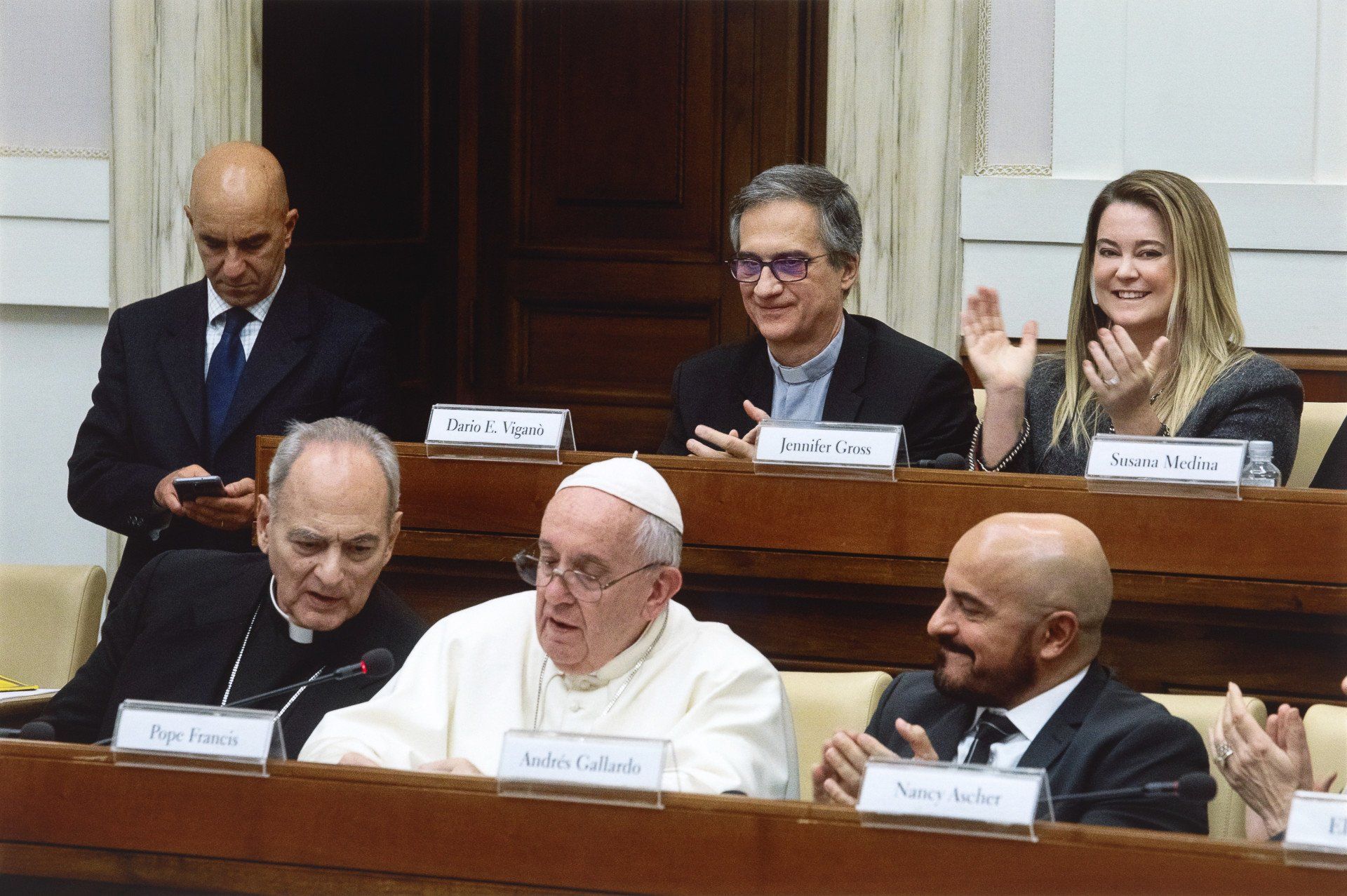 The pope sitting at a Vatican Summit conference talking into a mic