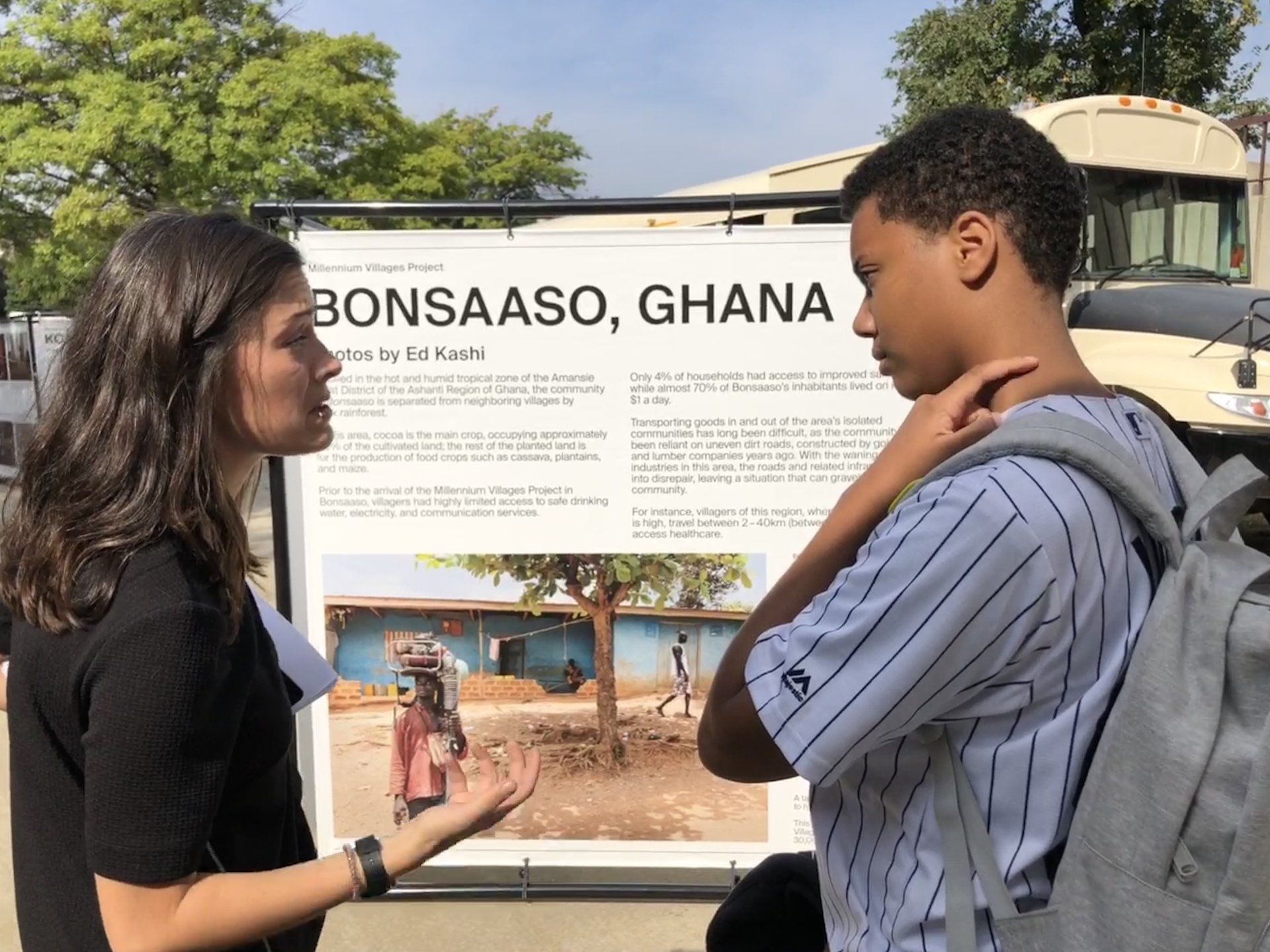 Teacher and student discuss Traveling Education Exhibit from Millennium Villages Project.