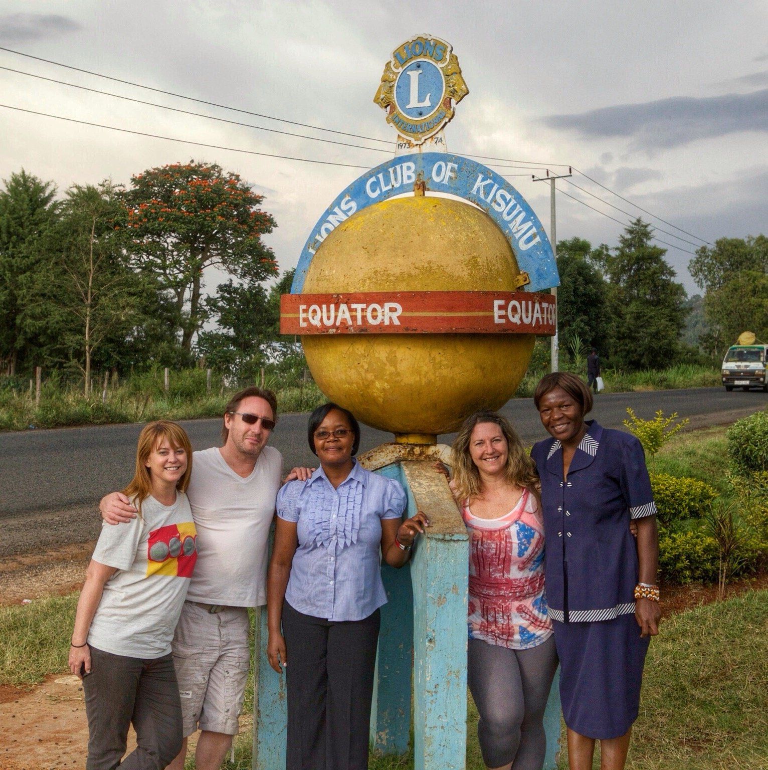 The White Feather Foundation: A group of men and women standing infront of a Lyons Club of Kisumu sign