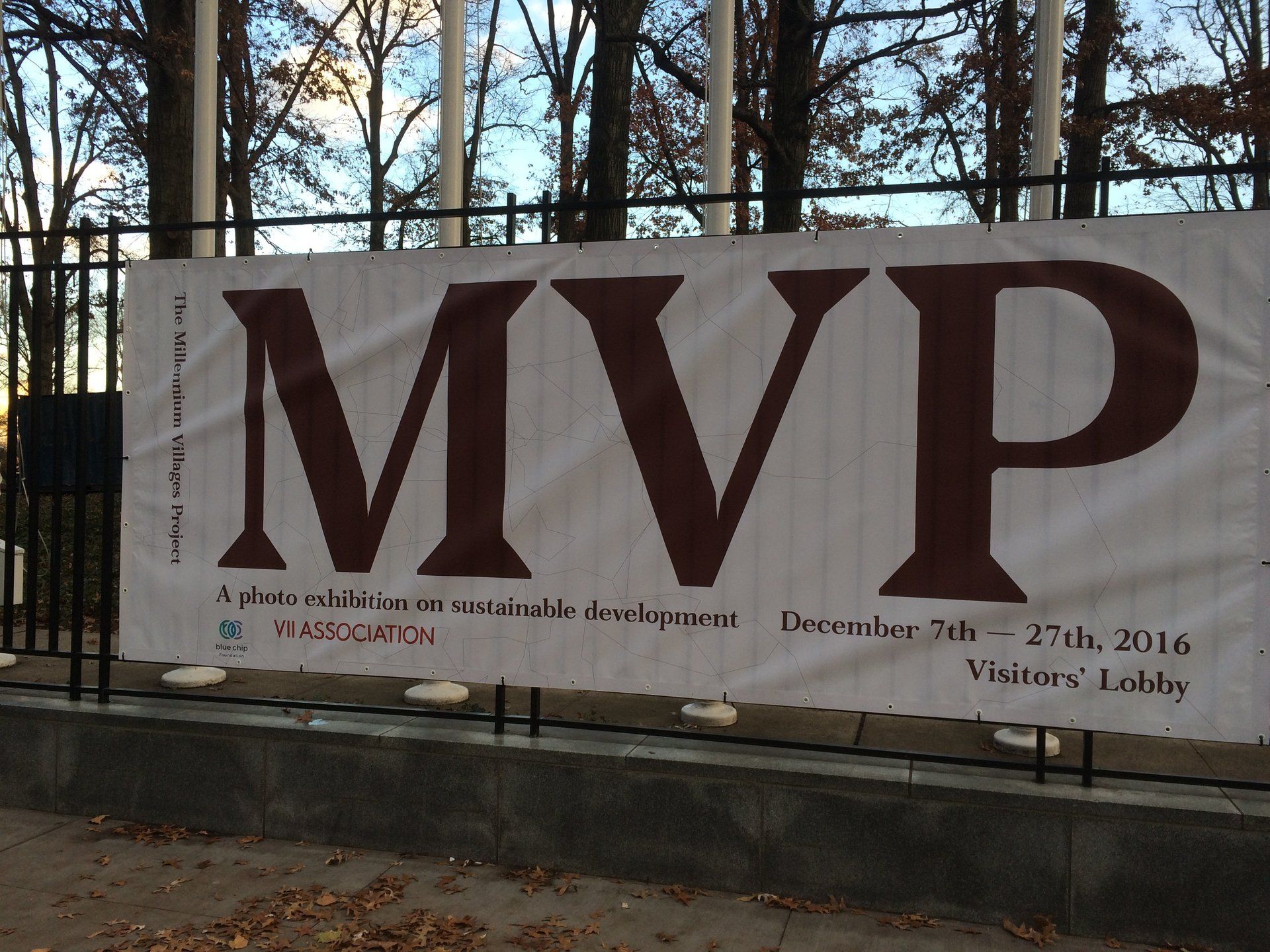 Millennium Villages Project (MVP) Logo banner hanging on a chain link fence