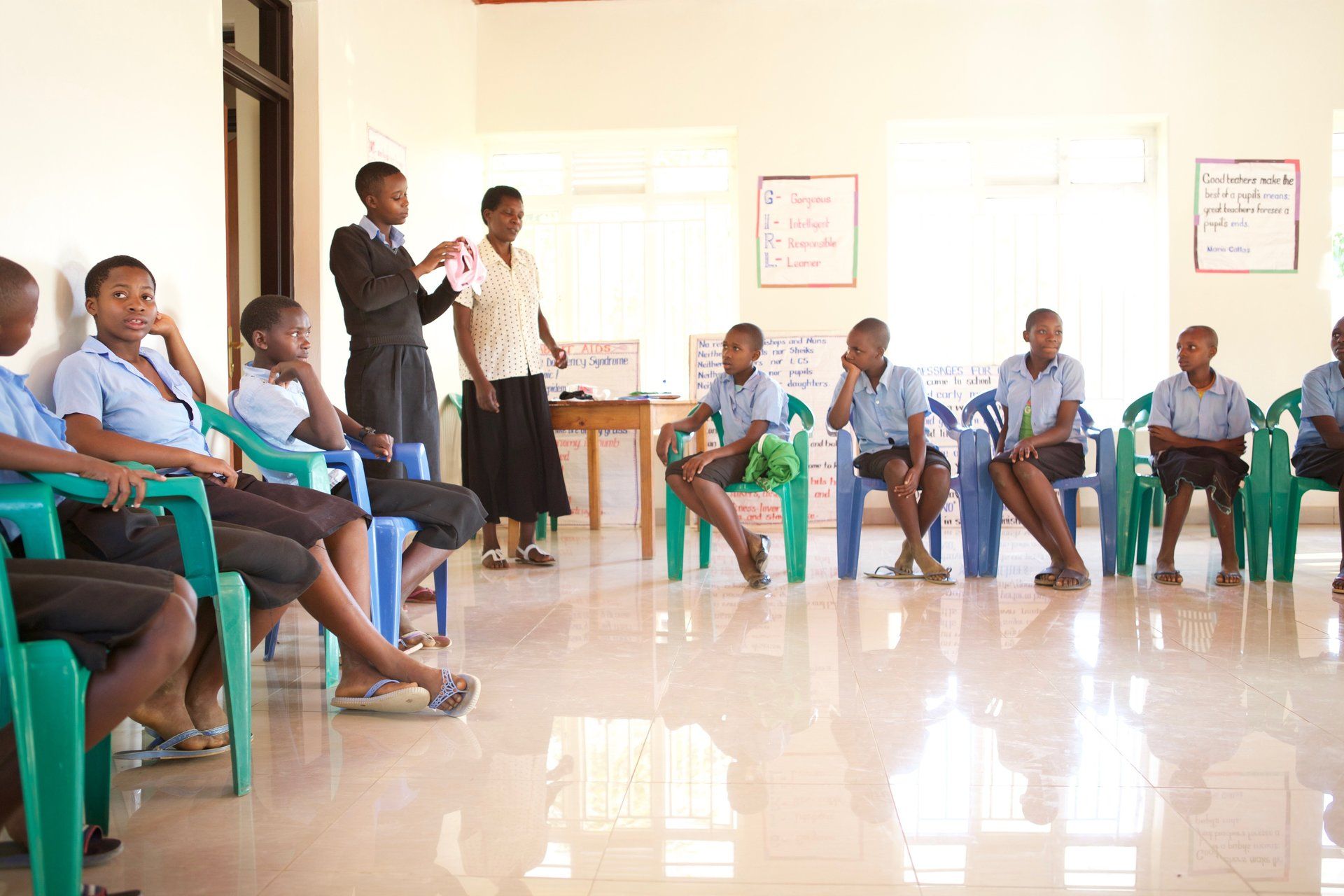 Classroom scene in Rwanda with engaged students and teacher, part of Millennium Villages education efforts.