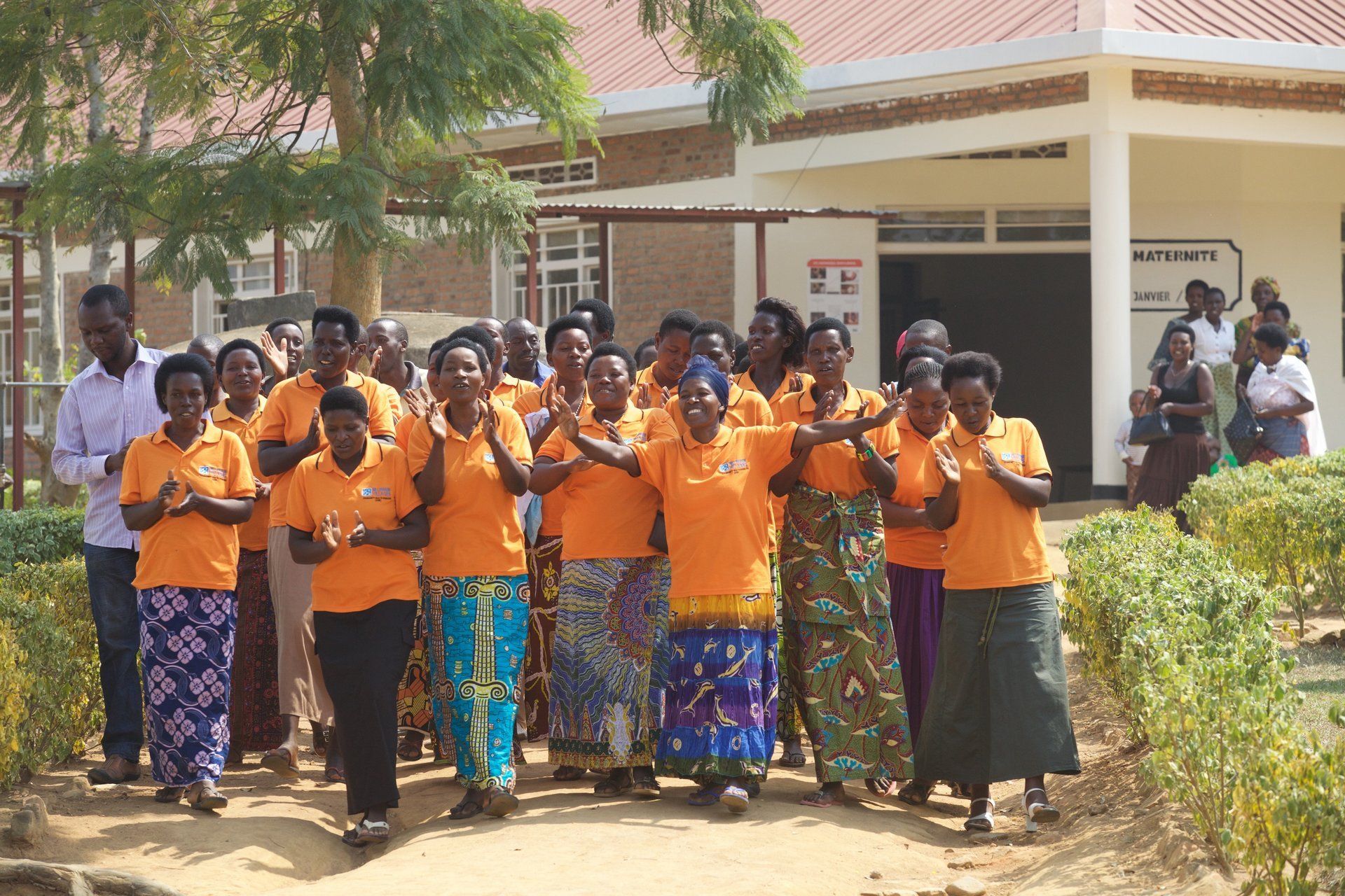 Community members in vibrant attire at ‘MATERNITE’ facility, part of Millennium Villages Project in Rwanda.
