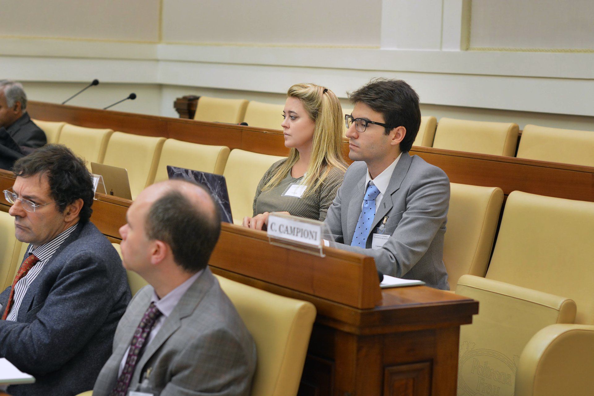 Jennifer Gross, Co-Founder of the Blue Chip Foundation sitting with two men at the Social Inclusion Workshop at Casina Pio IV