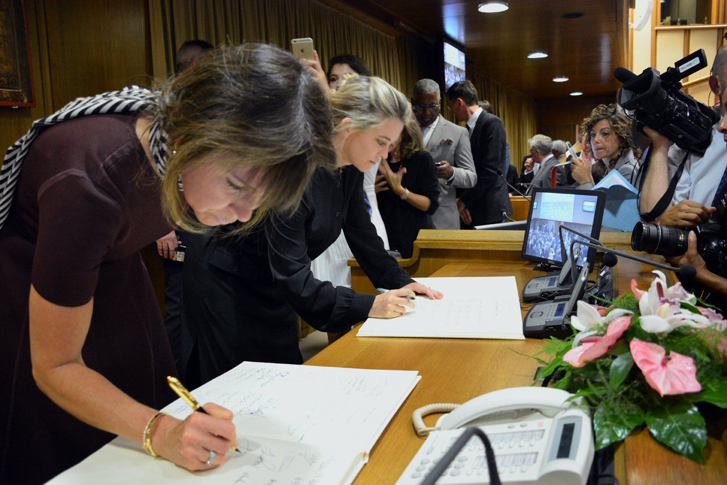Jennifer Gross co-founder of Blue Chip Foundation signing documents to address Modern Slavery and Climate Change