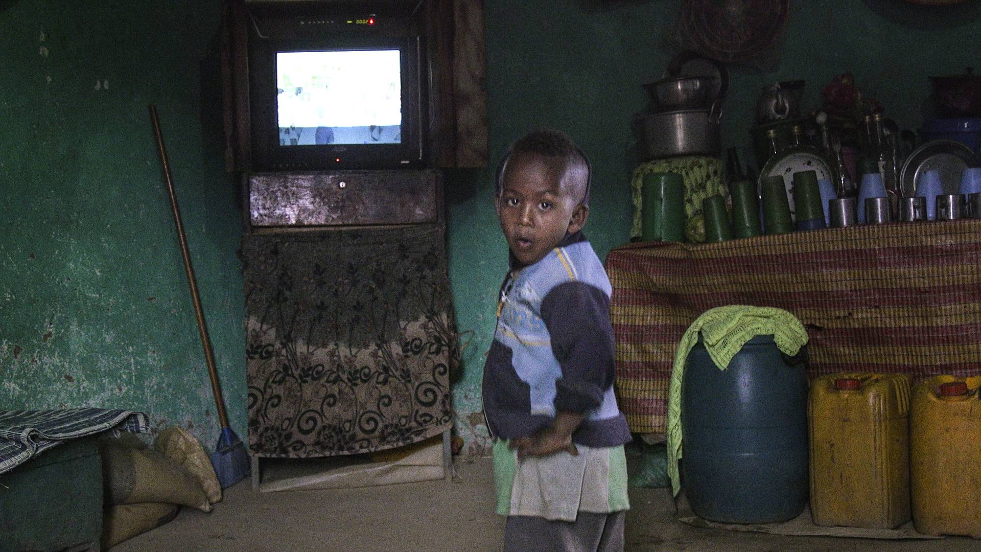 Get Involved: Young boy wearing blue sweater in a room