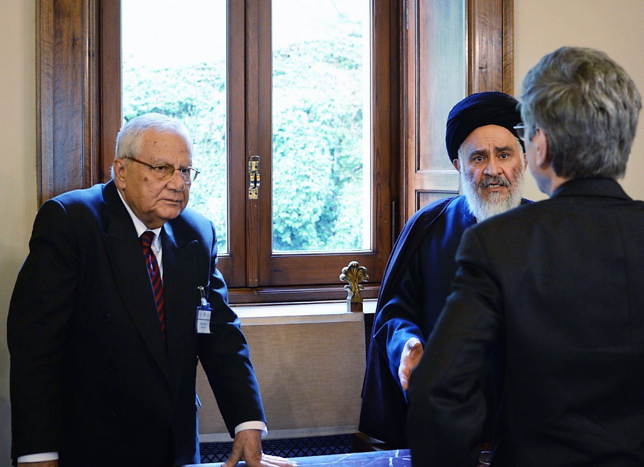 Two men talking at a Ethics in Action 3: Migrants and refugees