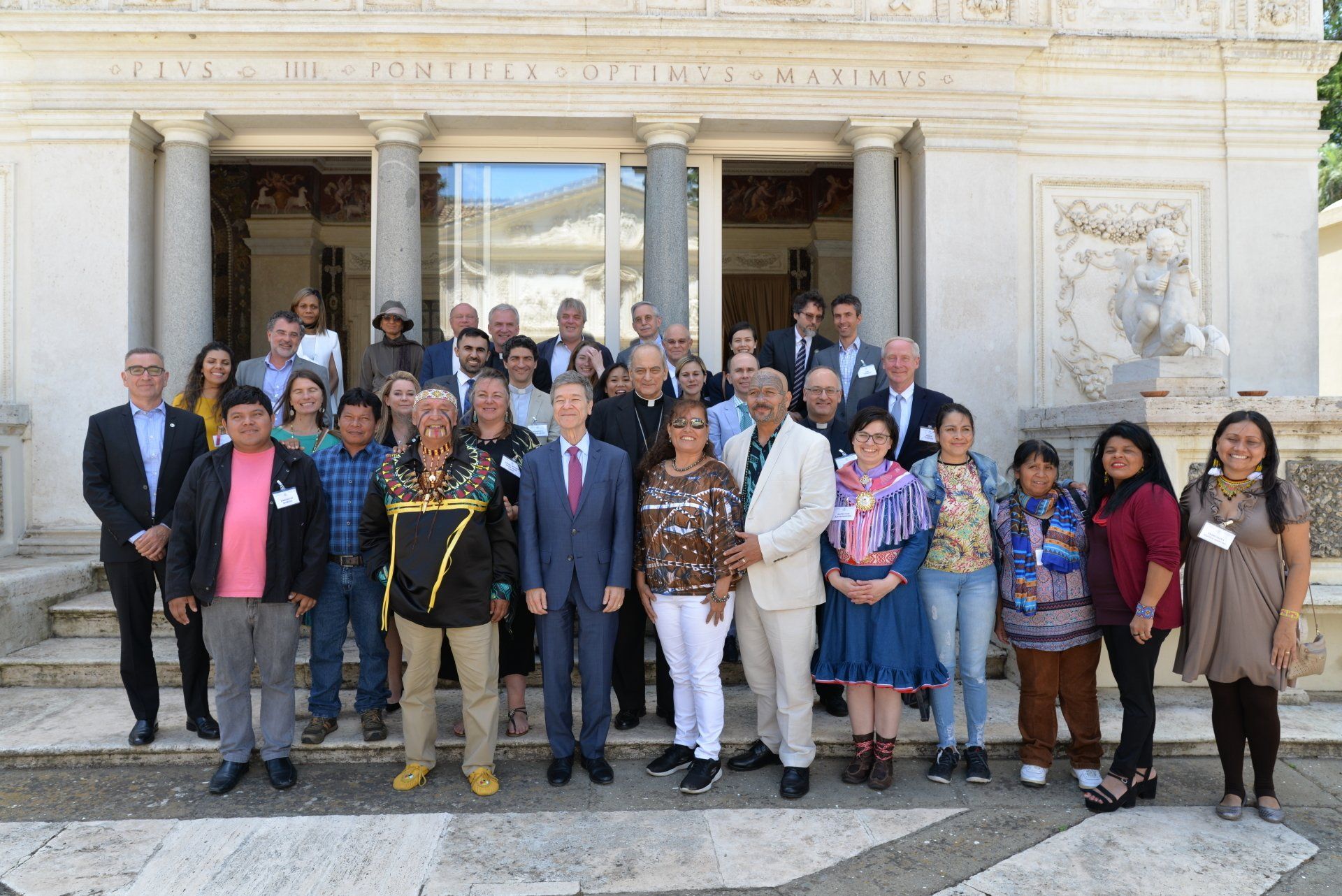 The whole group of people attending the Ethics in  Action and Indigenous Peoples meeting standing for a photo.