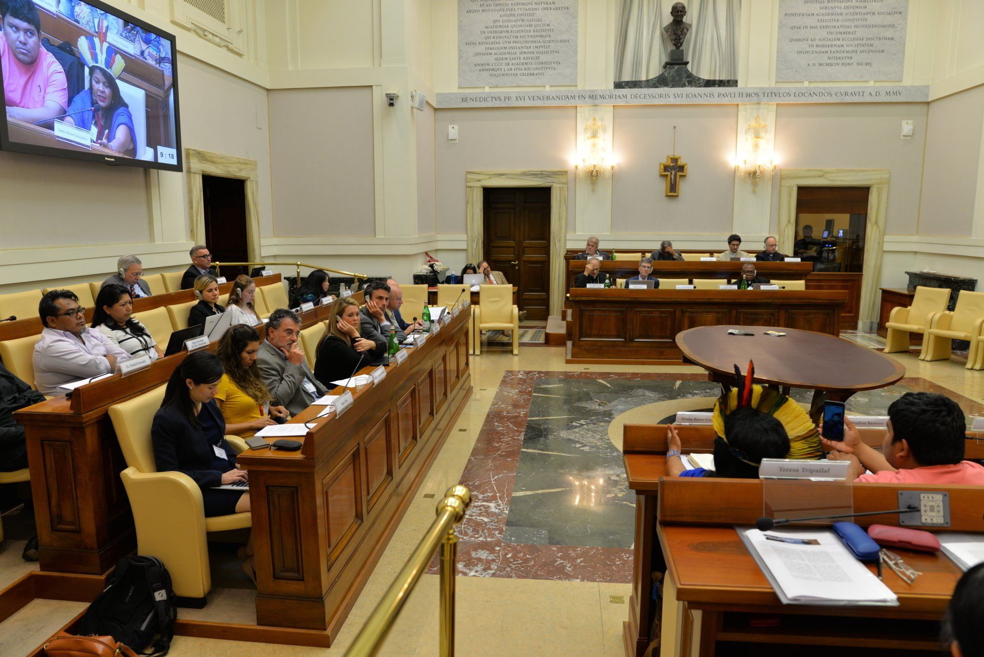 A large group of people meeting to talk about Ethics in  Action and Indigenous Peoples