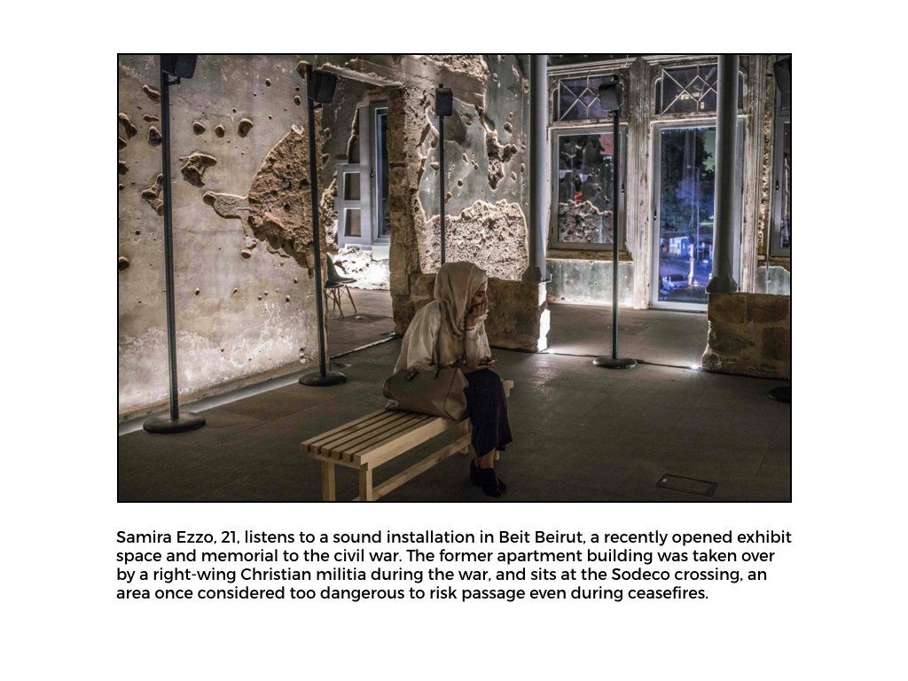 The Peace Project: A women sits in a exhibit listening to an installation in Beit Beirut, about the civil war