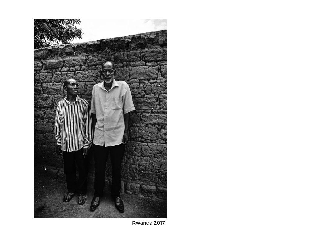 The Peace Project: Two men standing together with their backs against a stone wall