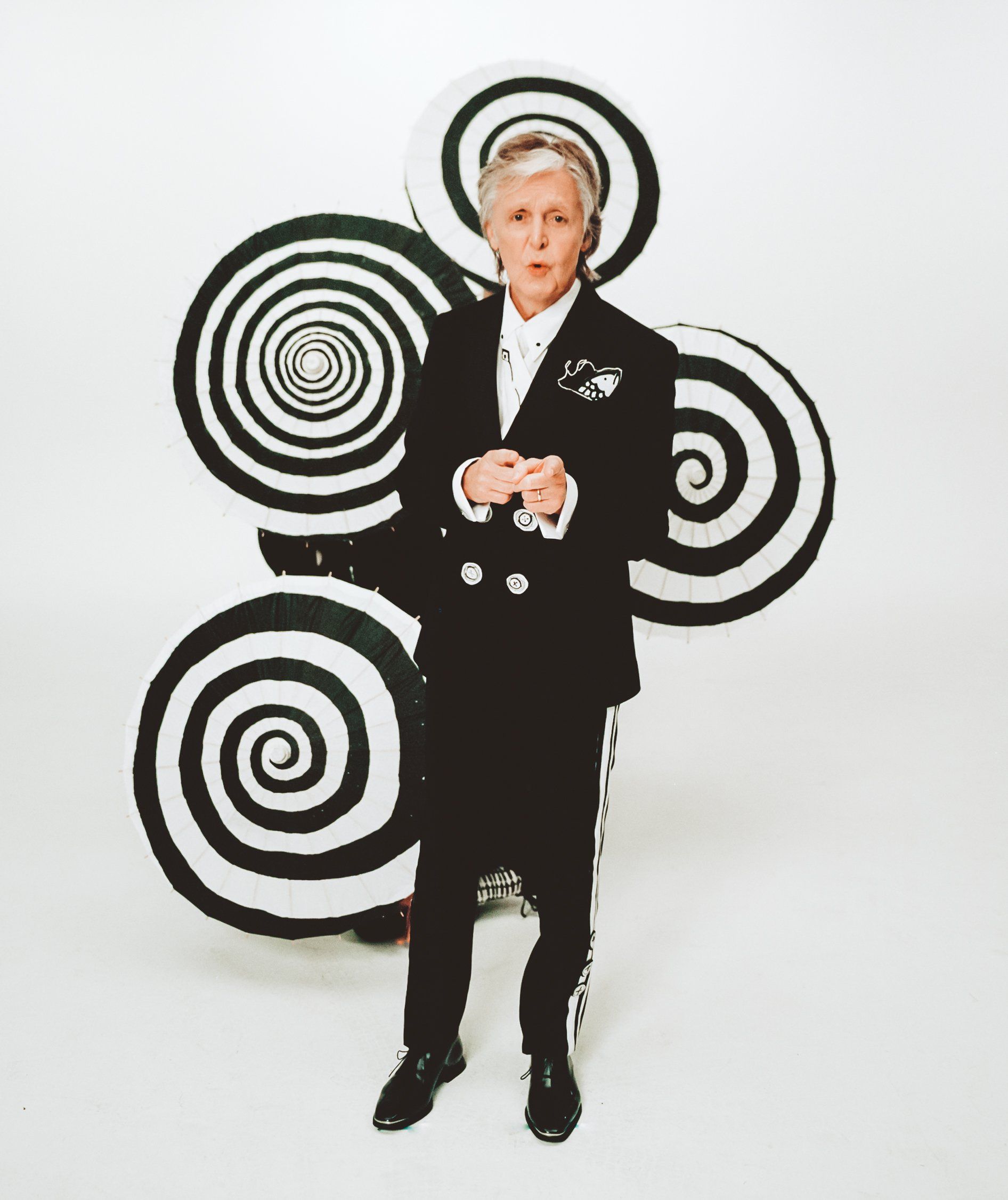 Who Cares I Do Campaign, Paul McCartney standing in front of a black and white swirly statue