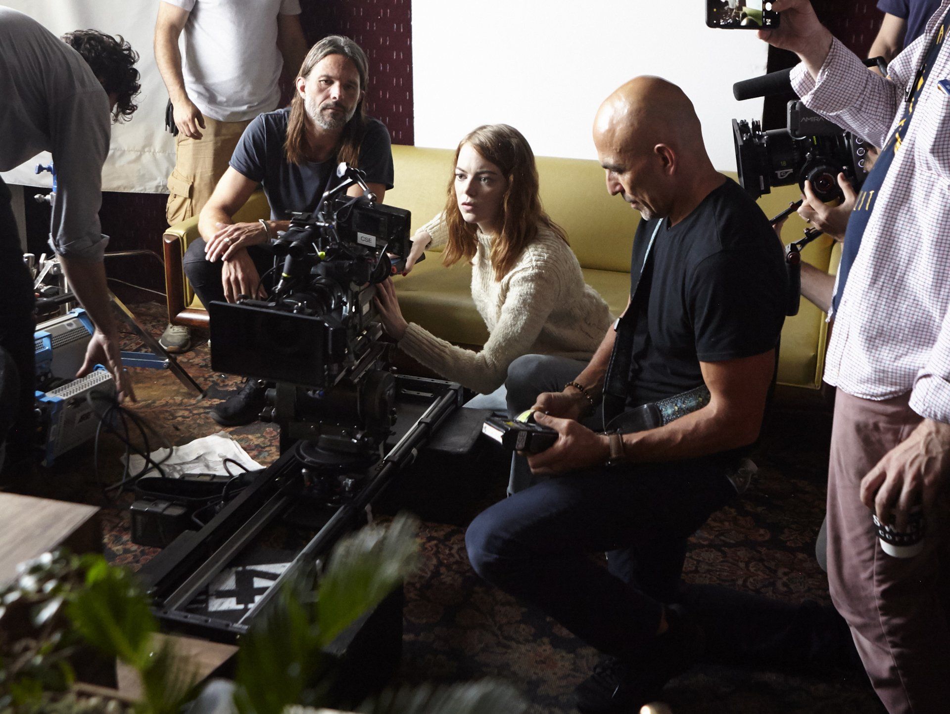 Emma stone and others looking at a camera during production