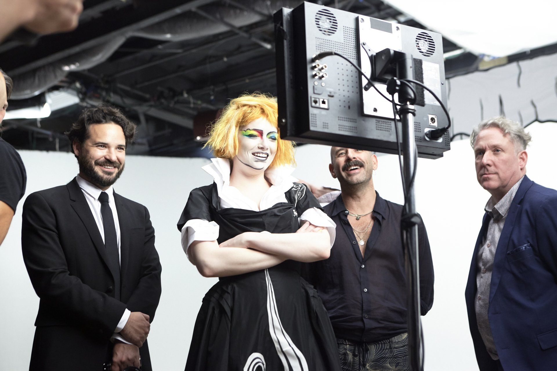 Emma Stone looking at a screen showing the production