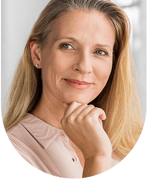 Woman with a smirk on her face, reflecting confidence after treatment at Hampstead Clinic