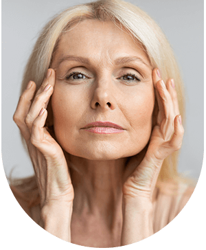 Woman touching her face, highlighting facial fine line reduction treatment at Hampstead Clinic