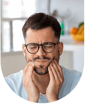 Man in discomfort, representing facial pain and bruxism issues at Hampstead Clinic