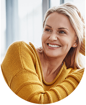 Smiling woman with dental crowns, highlighting restoration and aesthetics at Hampstead Clinic