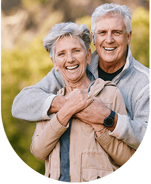 Smiling older couple with dental crowns, highlighting restoration and aesthetics at Hampstead Clinic