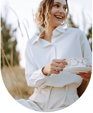 Woman with a cup of tea, considering if dermal fillers are right for her at Hampstead Clinic