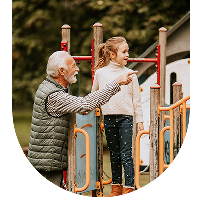 Grandparent and grandchild on a climbing frame, representing comprehensive family dental care at Hampstead Clinic