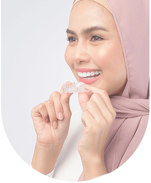 Lady holding Invisalign, preparing to start treatment at Hampstead Clinic