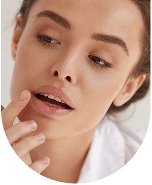 Woman touching her lip, illustrating lip enhancement treatment at Hampstead Clinic