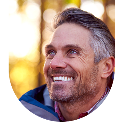 Close-up of a smiling man, highlighting the results of comprehensive dental cleanings at Hampstead Clinic