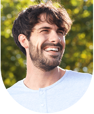 Young man showing bright smiles, highlighting tooth whitening benefits