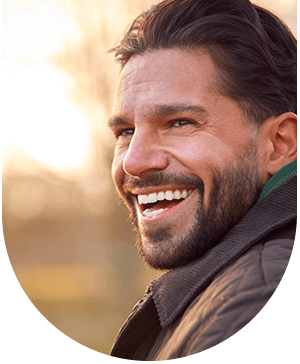 Man showing bright smiles, highlighting tooth whitening benefits