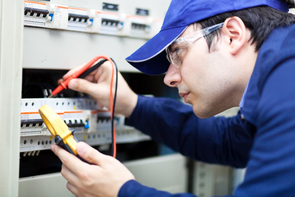 Electrician Testing Voltage With a Multimeter — Experienced Electrician In Port Stephens, NSW