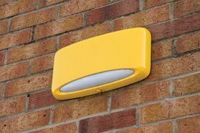Yellow burglar alarm on a wall