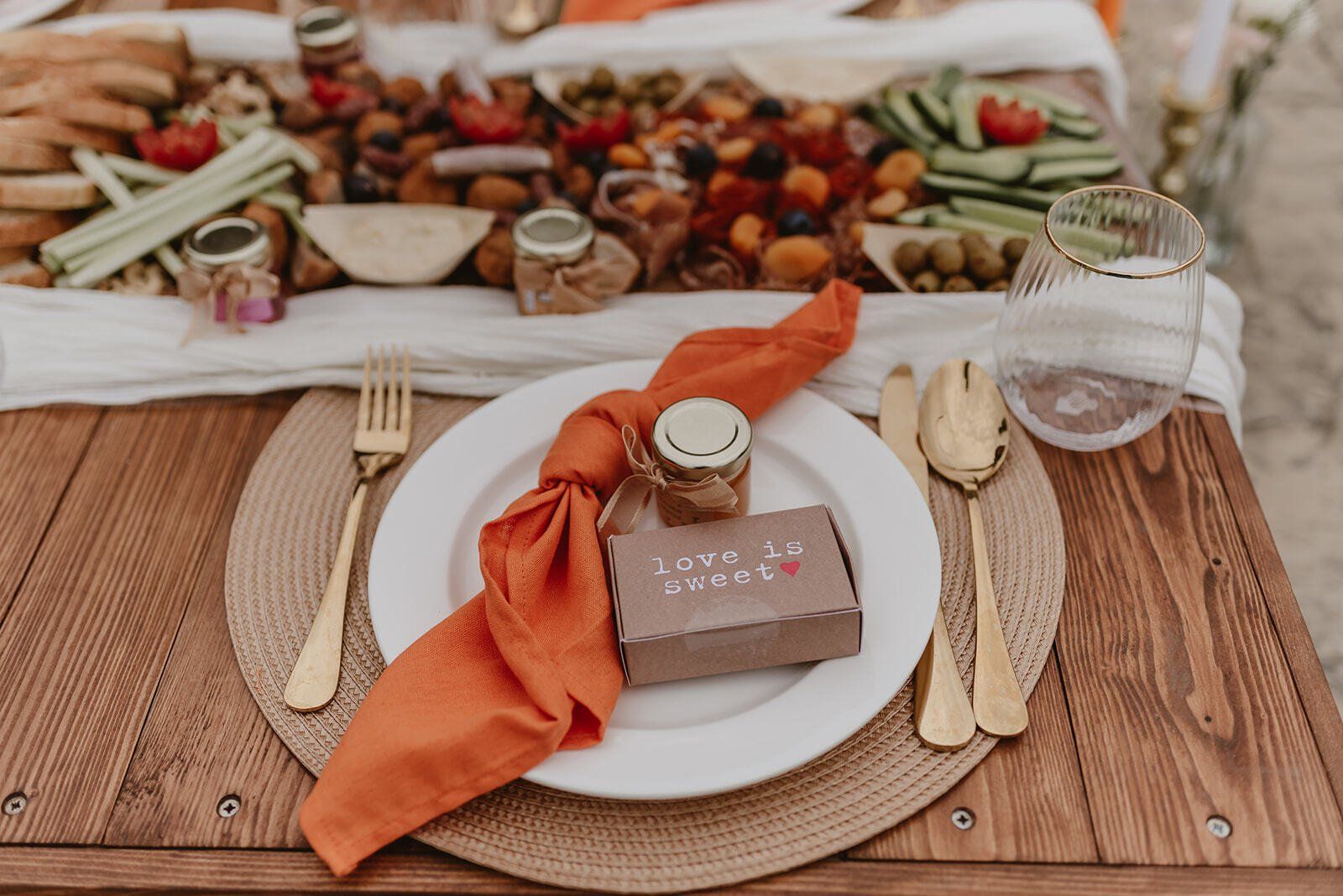 A wooden table with a plate of food and a napkin on it.